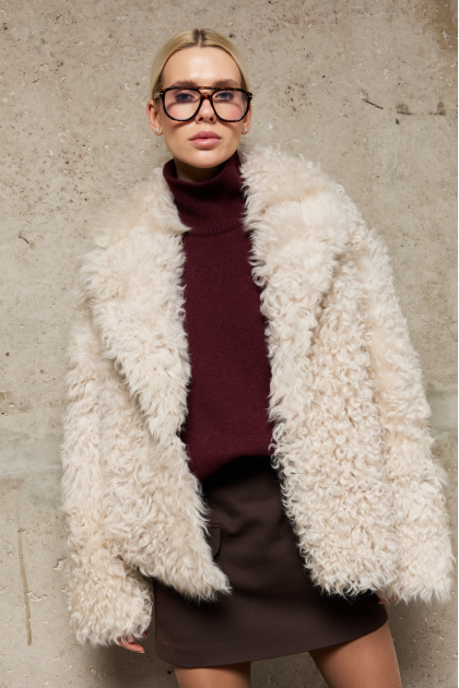 Short reversible sheepskin jacket made of natural sheepskin in light beige color